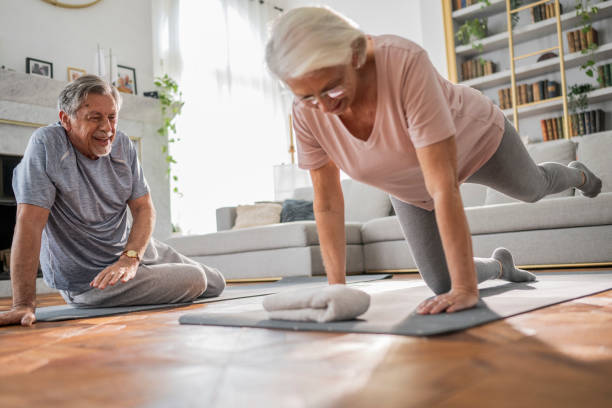 istock Elderly Couple Exercising at Home 2190533288