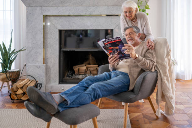 istock Elderly Couple Reading by the Fireplace 2190533460