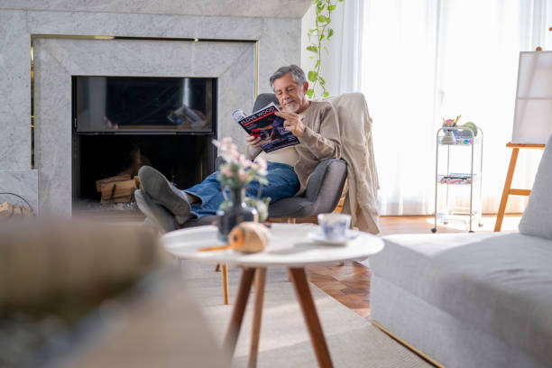 istock Elderly Man Reading in a Cozy Living Room 2190533470