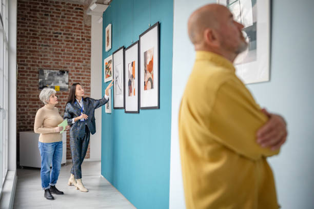 istock People Viewing Art in a Contemporary Gallery with a Curator Explaining 2190533587