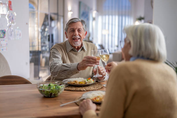 istock Senior Couple Celebratory Dinner Toast at Home 2190533922