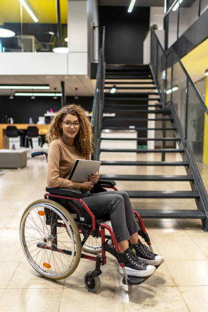 istock Woman sits in a wheelchair 2190534963