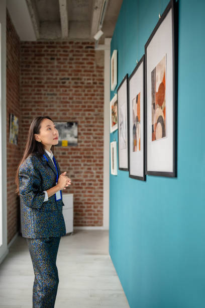 istock Curator observing abstract art pieces displayed in a modern gallery setting 2190535002