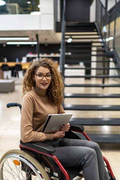 istock Woman sits in a wheelchair 2190535029