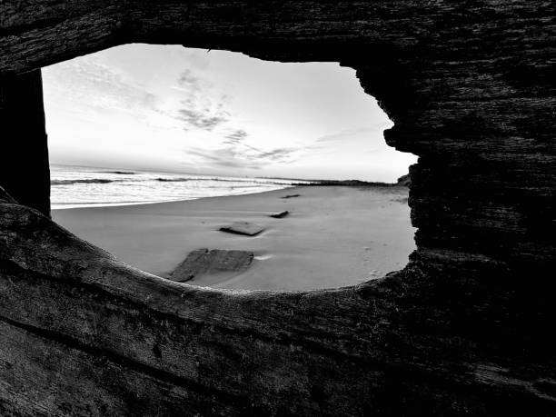 Looking through a hole in groyne over Blyth beach in Northumberland