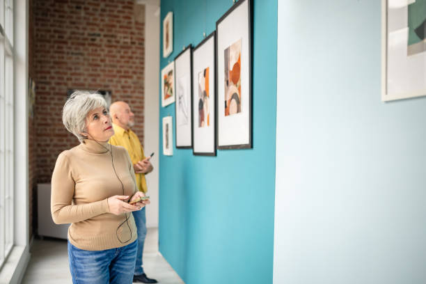 istock Visitors appreciating art in a contemporary gallery exhibition 2190535324