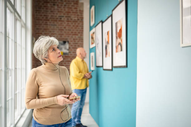 istock Visitors exploring an art gallery with a curator guiding the experience 2190535436