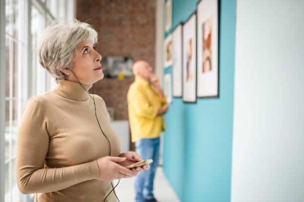istock Visitors exploring art gallery exhibits with one curator guiding the experience 2190535626