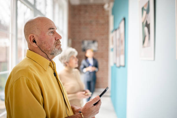istock Visitors exploring an art gallery exhibition with curator assisting 2190536421