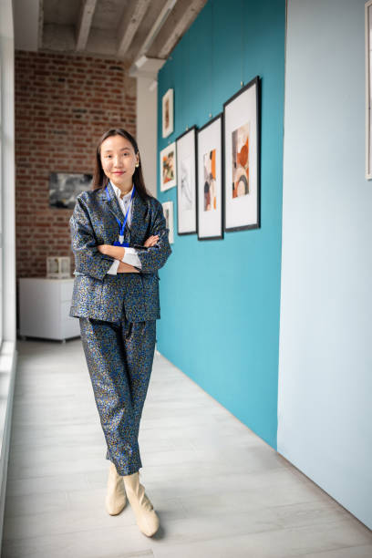 Art gallery curator standing confidently in a modern exhibition space