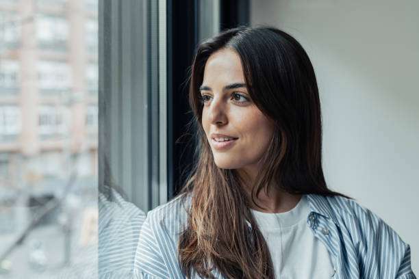 istock Head shot close up dreamy young smiling beautiful woman looking away, visualizing future indoors of recollecting good memories. Happy healthy millennial girl enjoying free weekend time at home. 2190537021