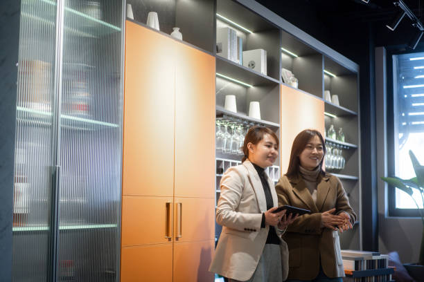 istock Asian female salespersons are communicating with clients while holding digital tablets. 2190537306