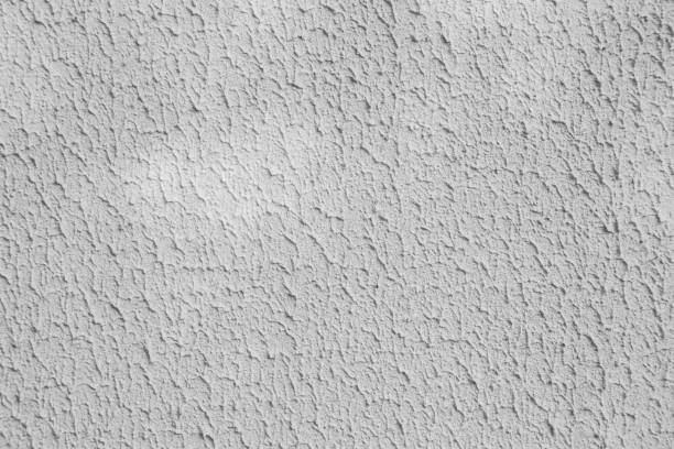 istock Rough plaster on the wall with stains from the incident light. 2190540523