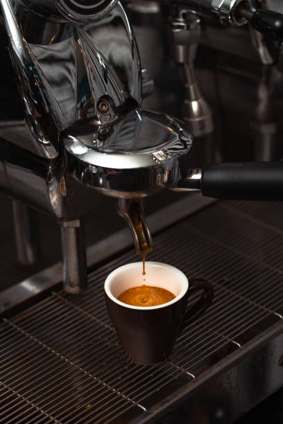 istock Extraction of a Perfect Espresso Shot from an Espresso Machine into a Brown Cup 2190540633