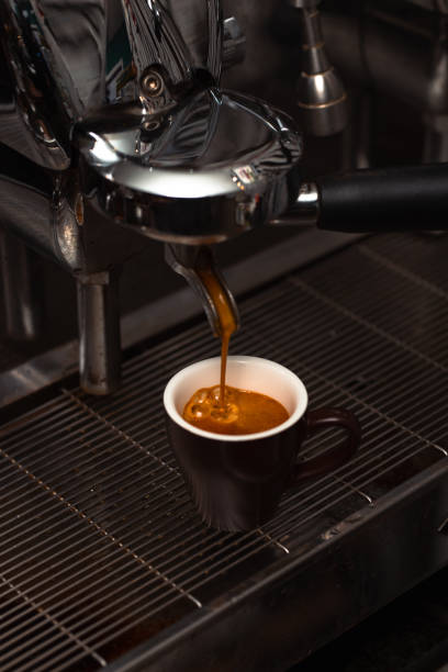 istock Extraction of a Perfect Espresso Shot from an Espresso Machine into a Brown Cup 2190540637
