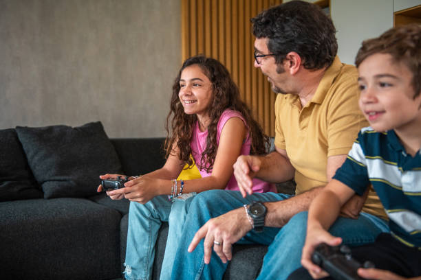 istock Hispanic Father Joyfully Engages with Kids in Video Gaming 2190541079