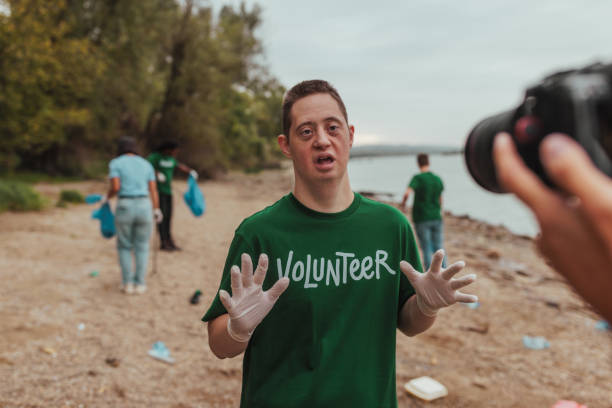 istock Volunteer activist with down syndrome explaining environmental project 2190541194