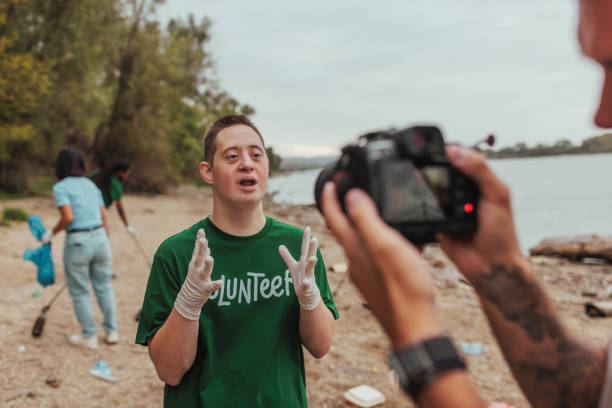 istock Volunteer with down syndrome giving interview about cleaning the beach 2190541198