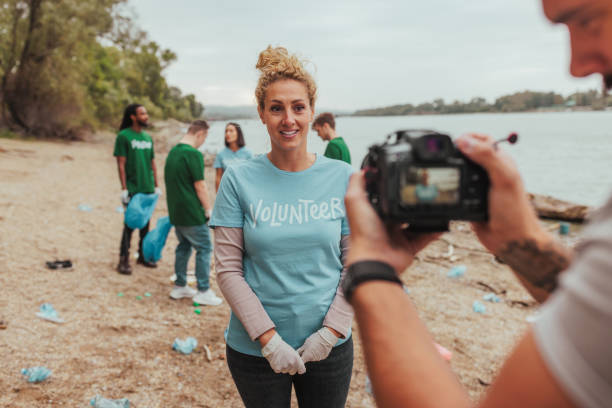 istock Videographer filming volunteer during river cleanup event 2190541227