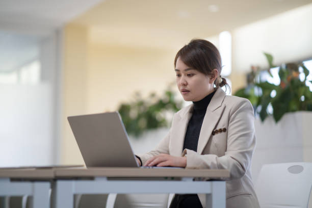 istock two businesswoman using laptop in office 2190543127
