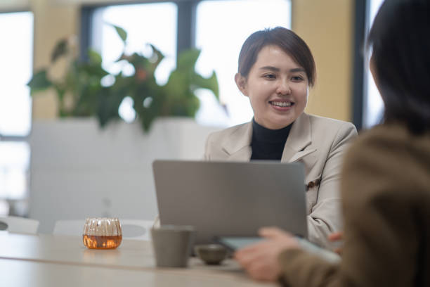 istock two businesswoman using laptop in office 2190543129