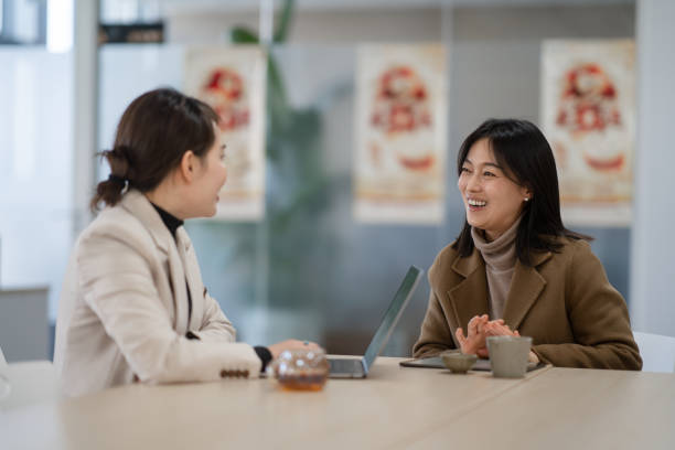 istock two businesswoman using laptop in office 2190543131