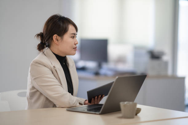 istock two businesswoman using laptop in office 2190543149