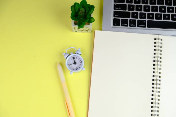 istock Home office workspace mockup with laptop, clipboard, palm leaf, notebook and accessories. Flat lay, top view 2190547924