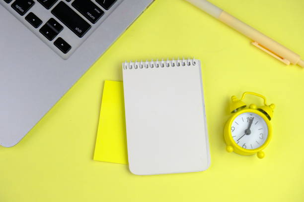 istock Home office workspace mockup with laptop, clipboard, palm leaf, notebook and accessories. Flat lay, top view 2190547946