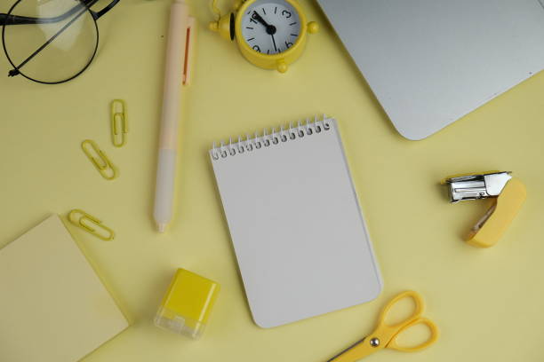 istock Home office workspace mockup with laptop, clipboard, palm leaf, notebook and accessories. Flat lay, top view 2190547988