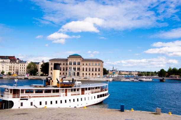 Stockholm harbor reflects the pastel hues of dawn, showcasing the city's serene beauty and maritime heritage