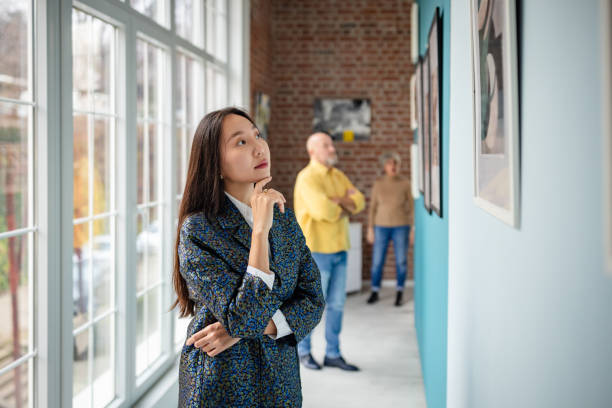 istock Curator and visitors observing artworks in a contemporary art gallery setting 2190549957