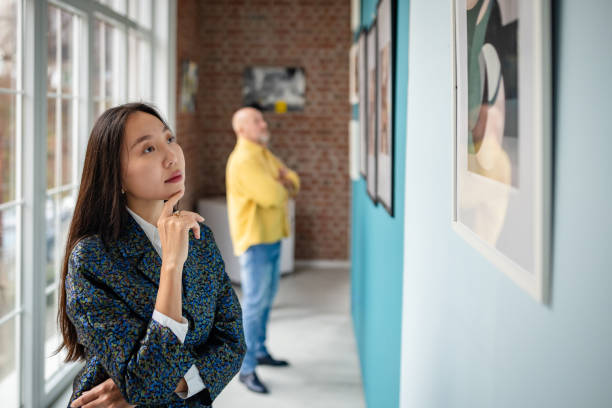 istock Art enthusiasts observing exhibits in gallery interior with natural lighting. 2190550019