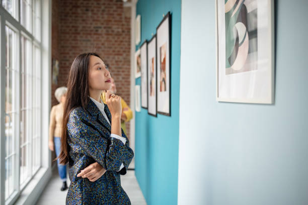 istock Curator Analyzing Artwork in a Vibrant Art Gallery Display 2190550058