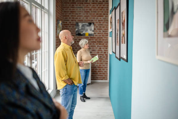 istock Visitors admiring art in a modern gallery with diverse individuals 2190550291
