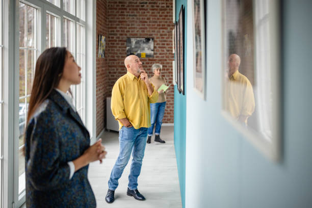 istock People appreciating art in a modern gallery with diverse individuals 2190550388