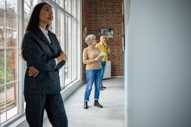 istock Visitors admiring artwork in an art gallery guided by a gallery curator 2190550410