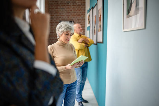 istock Visitors observing artwork in an art gallery with a curator present 2190550513
