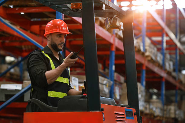 istock Caucasian Foreman stays on lifting forklift container cargo forklift using walkie talkie for communication and control forklift, concept service transportation logistics 2190551319