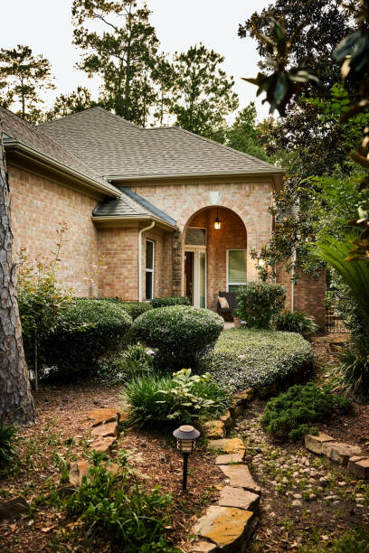 istock Picturesque stone and brick home with lush greenery  - Daytime version 2190551618