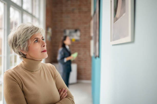 istock Visitors observing art displays in a modern gallery setting 2190551628