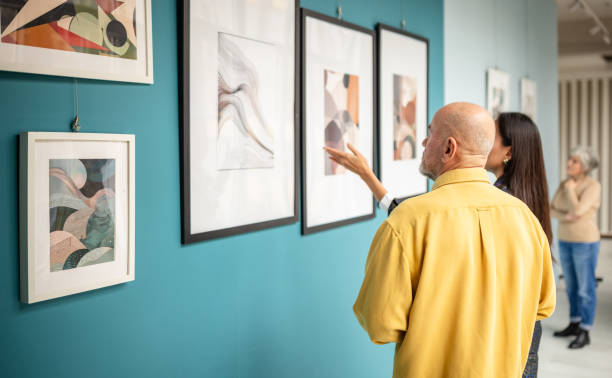 istock Visitors observing abstract artwork in a contemporary gallery exhibition 2190551843
