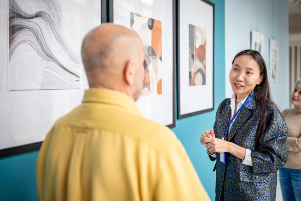 istock Art gallery curator explaining artwork to visitors during an exhibition 2190552118
