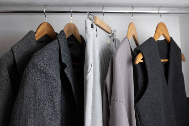istock Minimalist wardrobe with gray clothes hanging. 2190552285