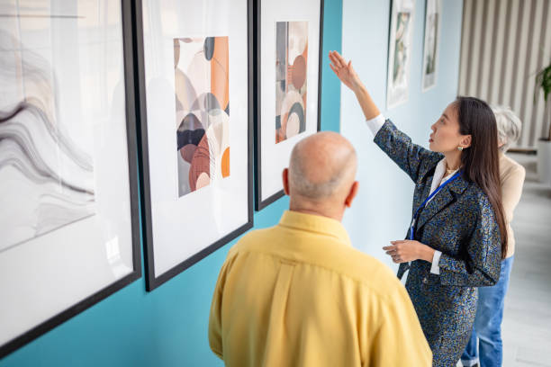 istock Art gallery curator presenting artwork to visitors in a contemporary setting 2190552298