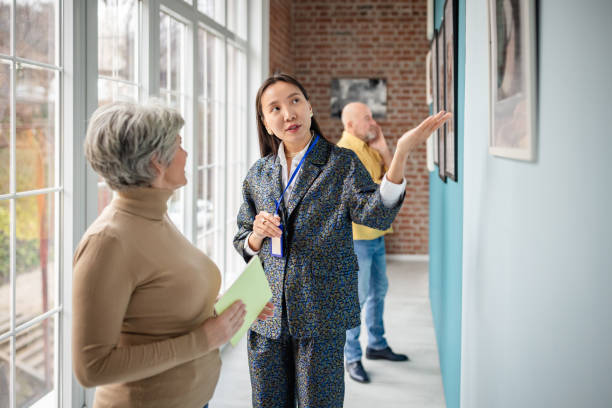 istock Curator explaining artwork to visitor in a contemporary art gallery 2190552617