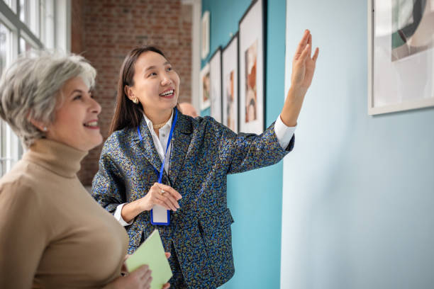 istock Art gallery curator guiding visitor during a captivating art exhibit tour 2190552705