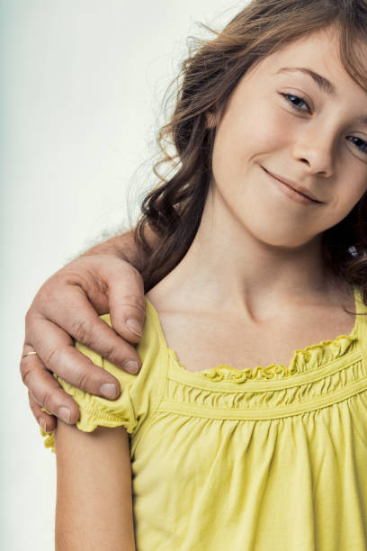 istock Father comforting his daughter by placing a hand on her shoulder 2190552935