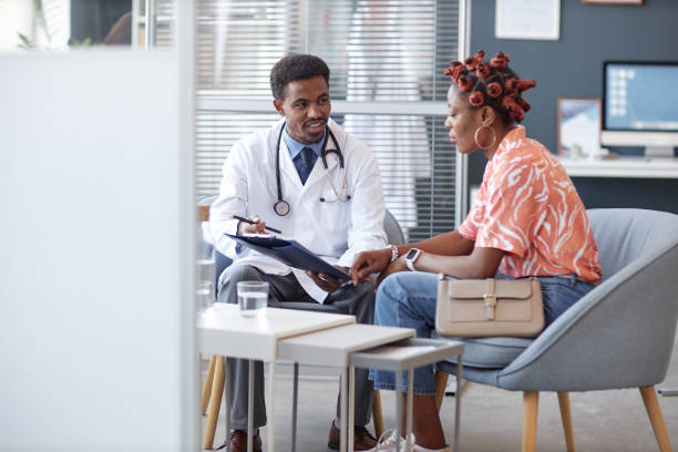 istock Black Doctor Holding Clipboard Discussing Treatment 2190554506