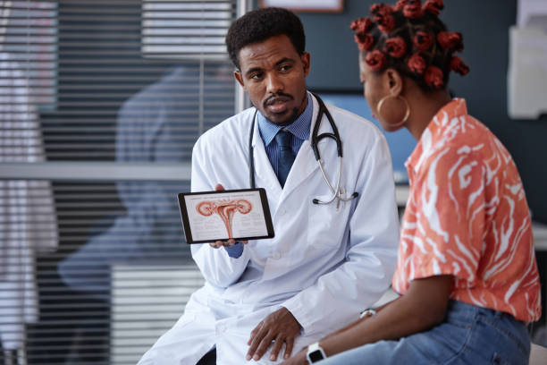 istock Male Gynecologist Holding Tablet Displaying Female Reproductive System 2190554521